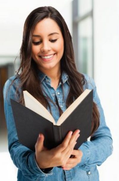 happy young woman with small book